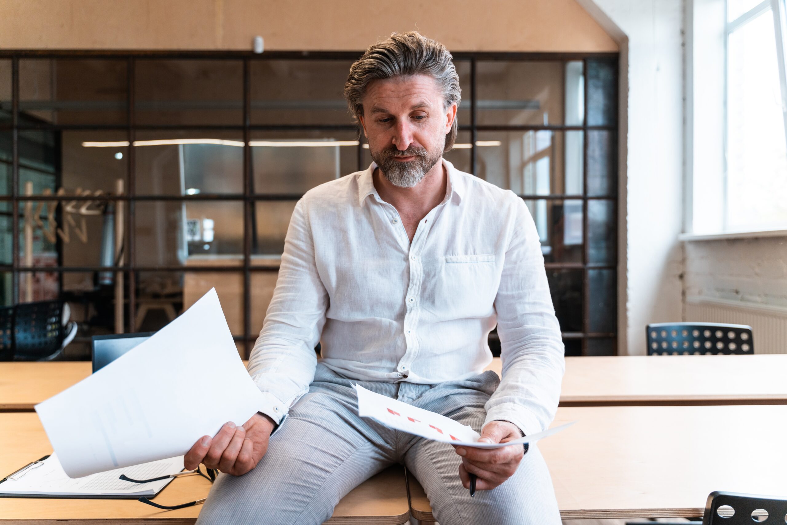 Senior,Business,Man,Sitting,In,His,Office,And,Taking,Care
