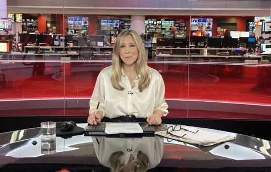 Joanna Gosling presenting the news in BBC studio directly facing the camera