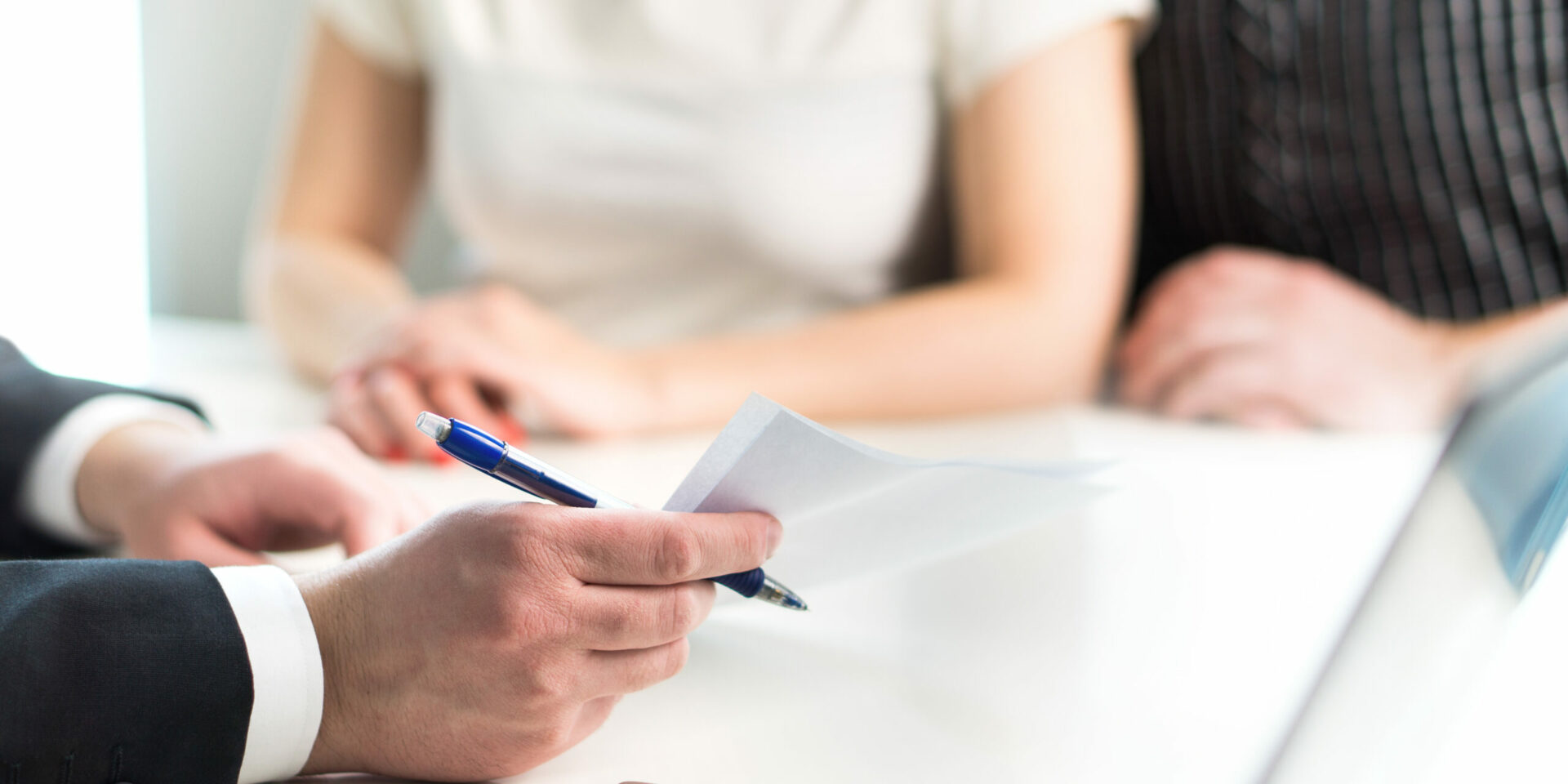 Lawyer showing paperwork to clients only hands visible