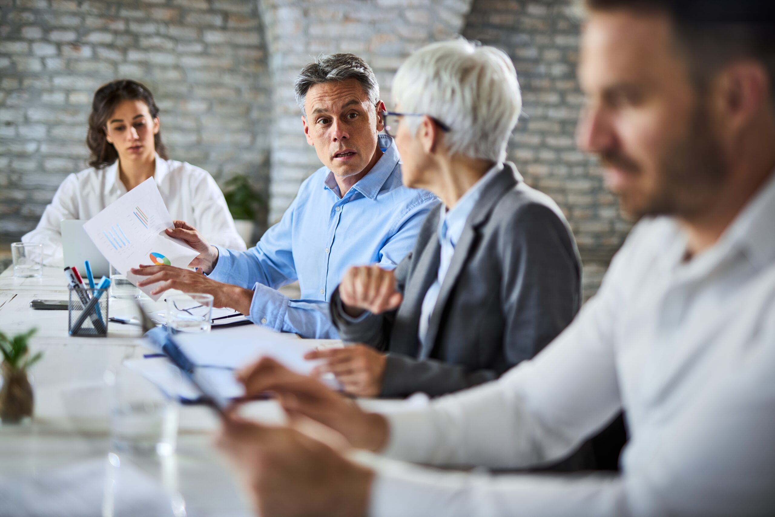 Mid,Adult,Businessman,And,His,Female,Colleague,Analyzing,Chart,During